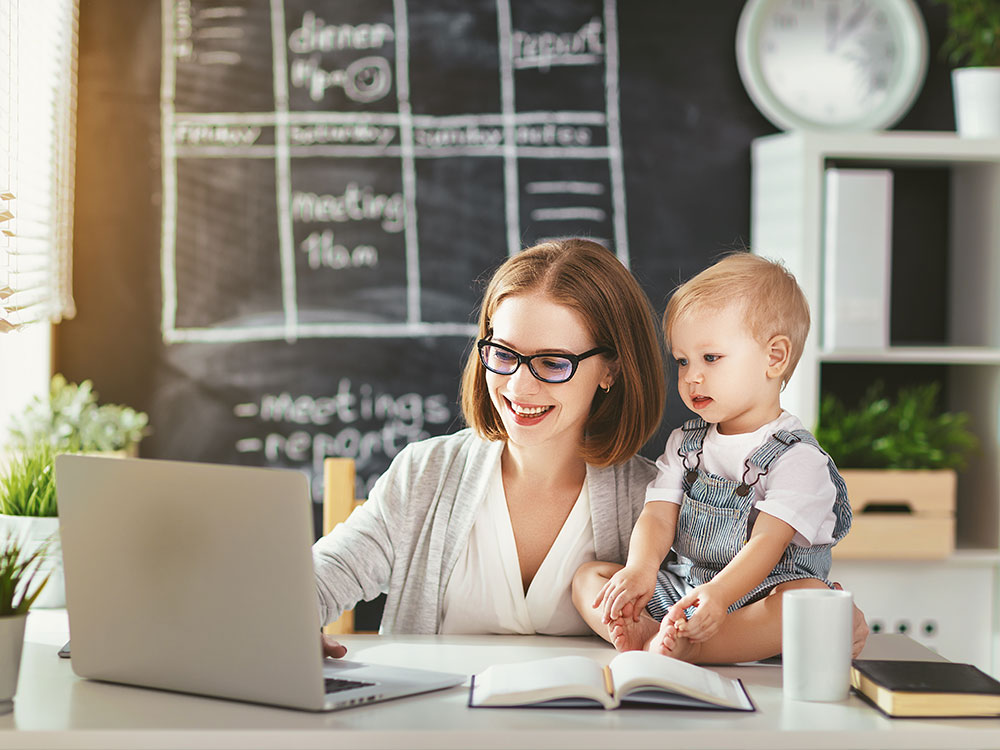 Mother with child whilst online learning