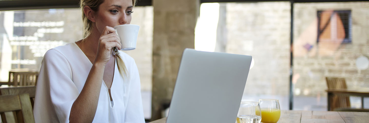 Woman online learning drinking coffee