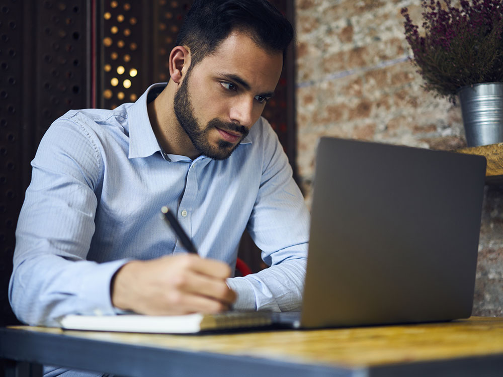 Man online learning on laptop