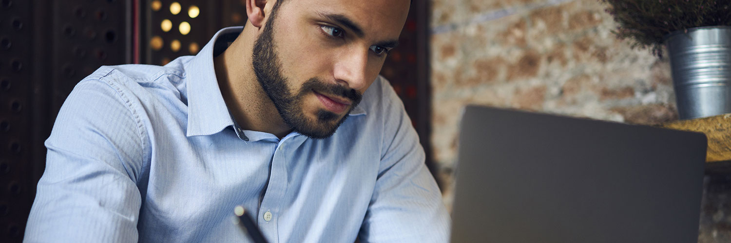 Man online learning on laptop