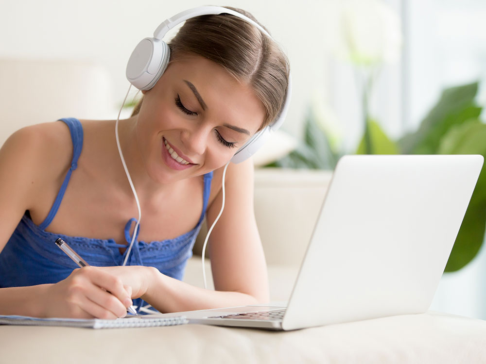 Woman listening to music whilst online learning