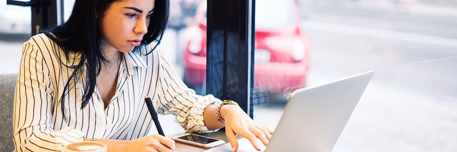 Woman online learning at coffee shop